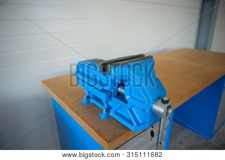 Shallow Depth Of Field Image With A Heavy Iron Vice On A Workbench Inside A Workshop With No People 