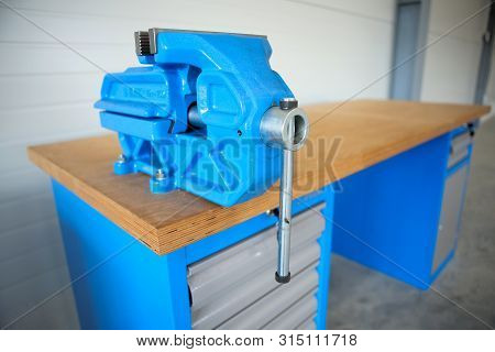 Shallow Depth Of Field Image With A Heavy Iron Vice On A Workbench Inside A Workshop With No People 