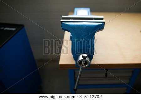 Shallow Depth Of Field Image With A Heavy Iron Vice On A Workbench Inside A Workshop With No People 