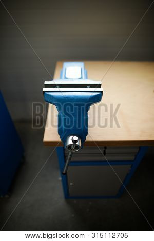 Shallow Depth Of Field Image With A Heavy Iron Vice On A Workbench Inside A Workshop With No People 