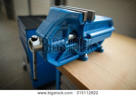 Shallow Depth Of Field Image With A Heavy Iron Vice On A Workbench Inside A Workshop With No People 