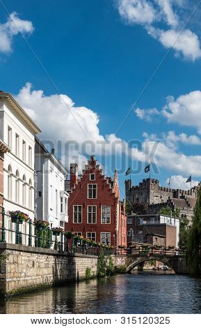 Gent, Flanders, Belgium -  June 21, 2019: Narrow Lieve River Leads Along Old Bourgeois Mansions To G