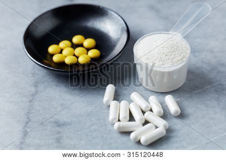 Collagen Powder, Proline Capsules And Vitamin C Tablets. Supplements To Support Collagen Production.
