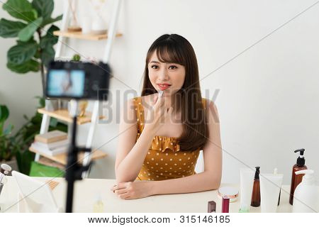 Girl Videoblogger Or Beauty Blogger Records Video For Subscribers. She Shows Lipstick And Tells How 