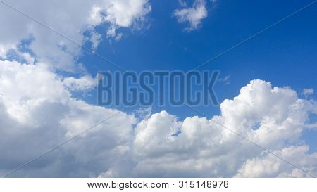 Beautiful Bright Blue Sky With White Fluffy Clouds On A Clear Sunny Day. Royalty High-quality Free S