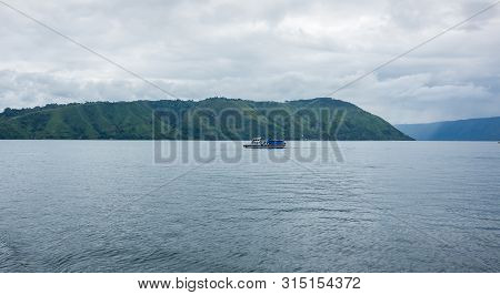 Lake Toba Is A Large Natural Lake Occupying The Caldera Of A Supervolcano, Located In The Middle Of 