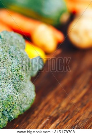 Fresh Salubrious Colourful Vegetables On Wooden Background, Broccoli In Focus, Potatoes, Carrots, Zu