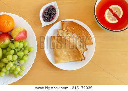 Delicious Pancakes, Crepes, Plate Of Fruits And Citrus Gelo. View From Above, Flat Lay
