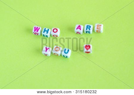 Phrase Who Are You Made Out Of Beads On Bright Background