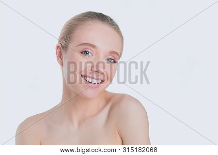 Portrait Of Beautiful Woman With Natural Make Up Touching Her Face.