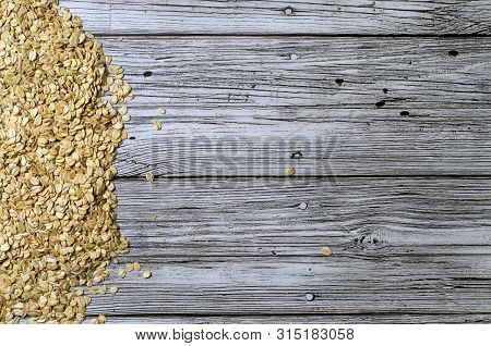 Oatmeal Scattered On A Wooden Table Top View With A Place For Inscription