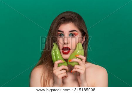 Closeup Portrait Of Beautiful Young Woman With Bright Color Make-up Holding Green Pepper Standing Is