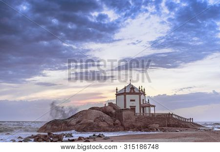 Sunset View On Capella Do Senhor Da Pedra At The Atlantic Ocean