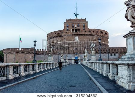 Lonely Priest On Ponte Santangelo With Castel Santangelo In Background At Early Morning - Rome, Ital