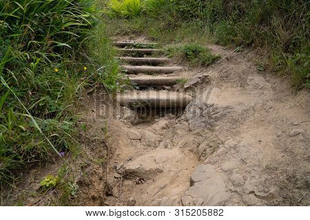 Rocky Stair Path On Dirt Trail Falling Apart With Some Weeds