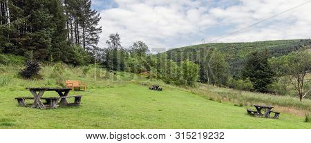 Wales Countryside View Of Picnic Benches In Hafren Forest Park In Summer