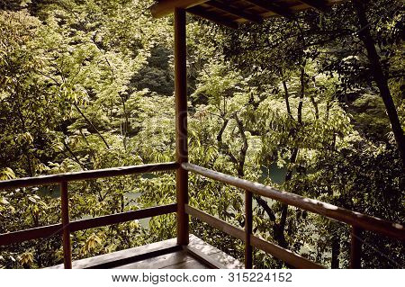 View Of Forest And Maple Trees From A Wooden Balcony Of An Old Building In Kyoto, Japan