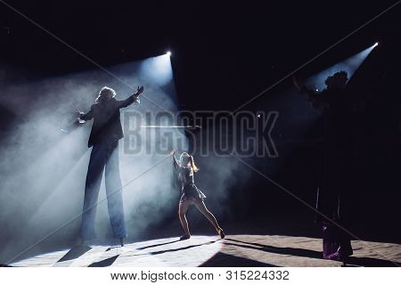 The Performance Of Stilt-walkers In The Circus