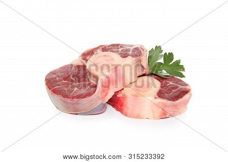 Two Pieces Of Raw Beef Shin With Bone And Parsley Leaves