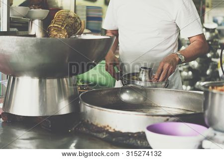 Asian Chef Cooking A Noodle Soup With Meat Ball (kauy-tiew) For Sale At Thai Street Food Market Or R