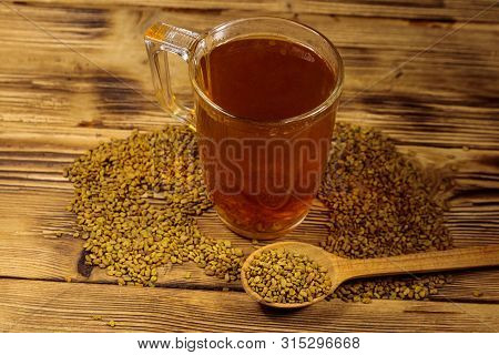 Egyptian Yellow Tea Or Methi Dana Drink And Fenugreek Seeds On Wooden Table