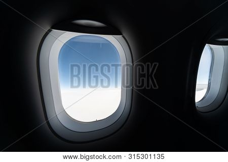 Airplane Window View To Cloudy Sky And Earth. Beautiful Landscape From Aircraft Cabin. Flying Withou