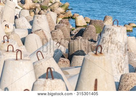 Breakwaters In Sea. Beautiful Sunset Seascape With Concrete Tetrapodes For Protect Coastal Structure