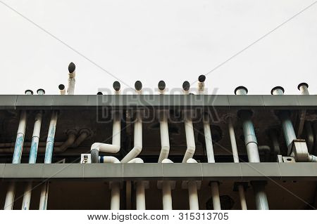Close Up Of The Factory Building With The Blue Sky.the Air Duct System Where Installed At The Factor