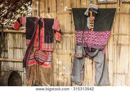 Colorful Tribal Costumes On The Bamboo Wall