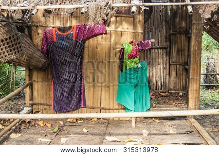 Colorful Tribal Costumes On The Bamboo Wall