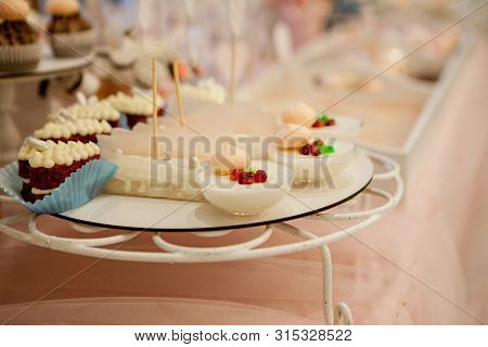 Panakota On The Wedding Table. Gentle White Wedding Cake And Different Sweets On Table.