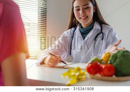 Nutrition. Asian Friendly Nutritionist Female Doctor Or Pretty Medical Talking About Diet Plan With 