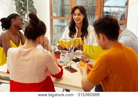 Group Of Cheerful Students Studying In Language School