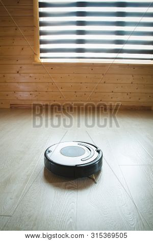 Robotic Vacuum Cleaner On The Floor. Blackground