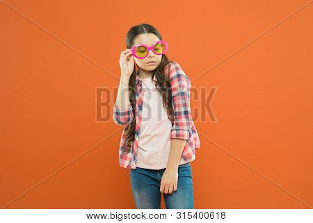 Fashionable Cutie. Being Smart. Little Smart Schoolgirl On Orange Background. Child Smart Look Throu