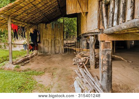 Chiang Mai, Thailand; July 2, 2019:clothes Hanging On Bamboo In Front Of Traditional Wooden House At