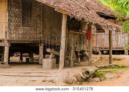 Chiang Mai, Thailand; July 2, 2019: Fire Extinguisher Handing On Support Pole Outside Traditional Wo