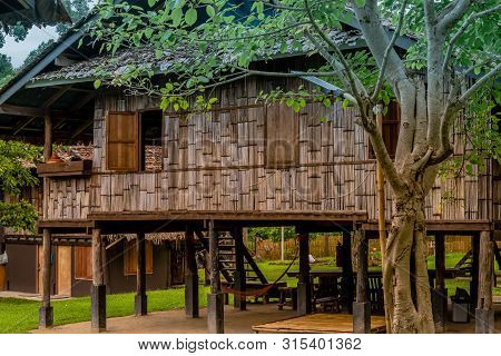 Chiang Mai, Thailand; July 2, 2019: Traditional Wooden House On Stilts With Open Windows Located At 