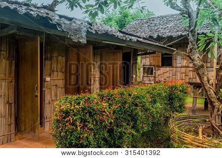 Chiang Mai, Thailand; July 2, 2019: Open Doors On Shared Toilets With Traditional House In Backgroun