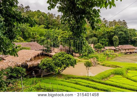 Chiang Mai, Thailand; July 2, 2019: Landscape Of Rice Paddies And Buildings Located At Chiang Doa Fi