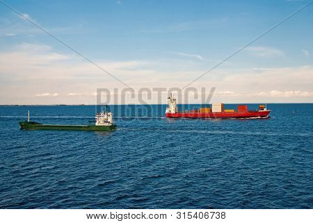 Barges Ship Cargo Containers In Sea In Copenhagen, Denmark. Cargo Ships Float In Blue Sea On Idyllic