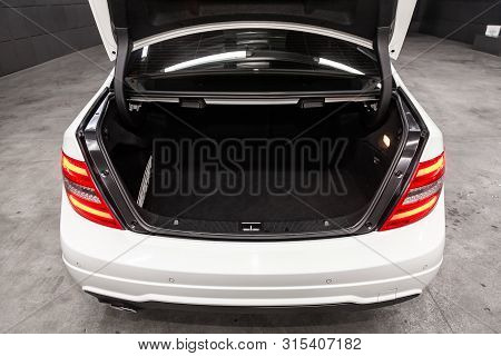Novosibirsk, Russia - July 12, 2019:   White Mercedes-benz C-class, Close-up Of The Open Trunk, Fron