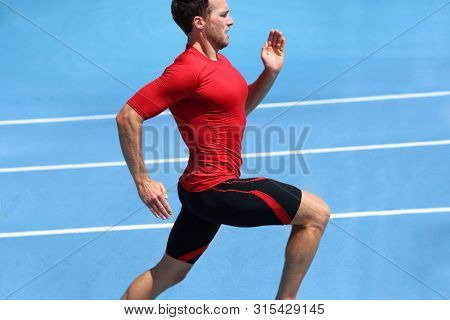 Fitness exercise sprint runner man sprinting on running track race.
