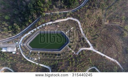 Farm Land With Rainfed Reservoir On The Hillfor Plantation Irrigated
