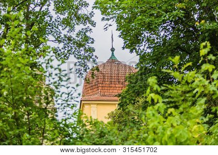 Panensky Tynec, Czech Republic - July 15 2019: Red Roof Of Yellow Bell Tower, A Part Of The Unfinish