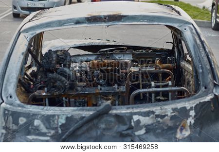 Burnt Car After A Fire, Body Parts Burnt Door Handles And Cracked Glass, The Picture Is Not Pleasant