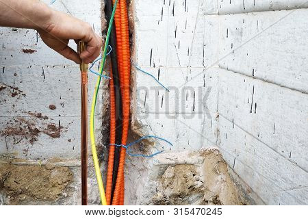 The Electrician Conducts Electrical Work On The Current Grounding Of The Current Drain.