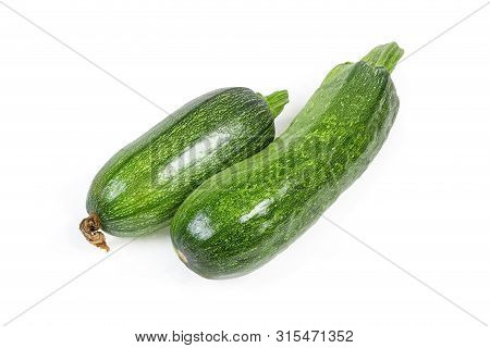 Two Fresh Raw Dark Green Zucchini On A White Background