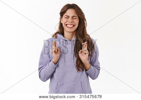 Girl Have To Win. Intense Nervous Young Hopeful Girl Close Eyes Clench Teeth Nervously Cross Fingers