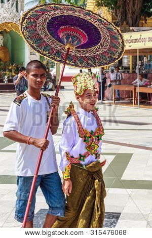 Yangon, Myanmar-may 6th 2014: Boy Dressed For Religious Ceremony In Shwedagon Pagod. The Pagoda Is T
